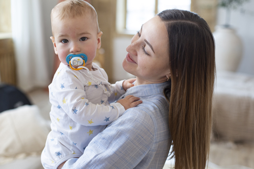 medium-shot-mother-holding-cute-baby